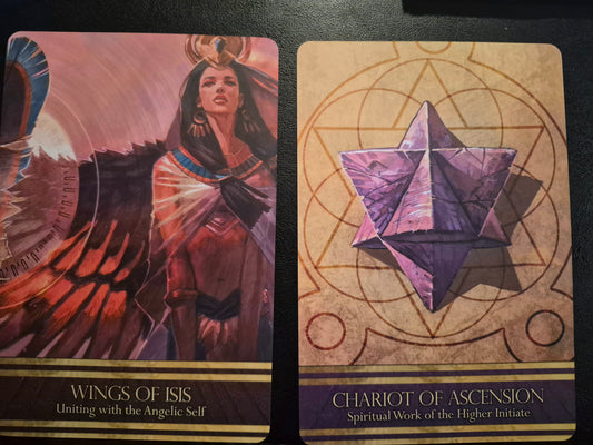 Two oracle cards, Wings of Isis and Chariot of Ascension, laid side by side for a daily collective reading.