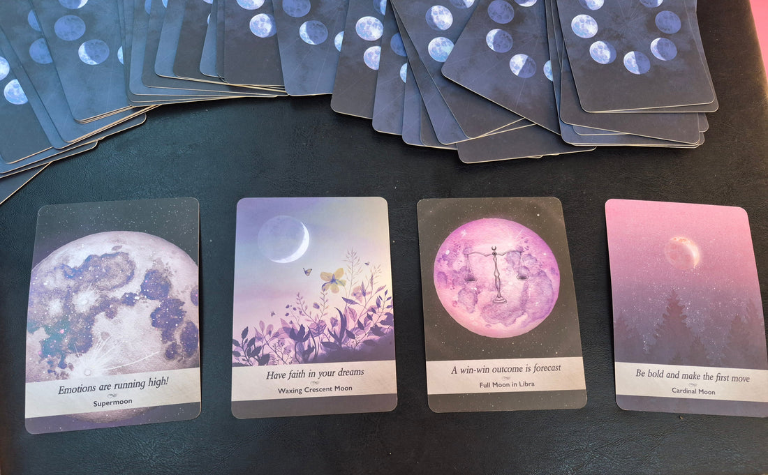 Four moon oracle cards laid out for the daily collective reading: Supermoon, Waxing Crescent Moon, Full Moon in Libra, and Cardinal Moon