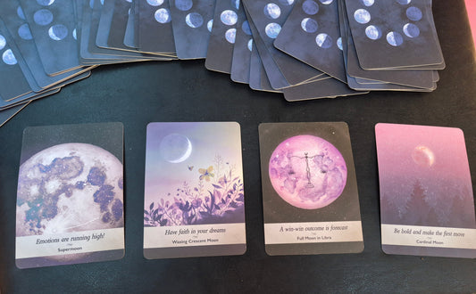 Four moon oracle cards laid out for the daily collective reading: Supermoon, Waxing Crescent Moon, Full Moon in Libra, and Cardinal Moon