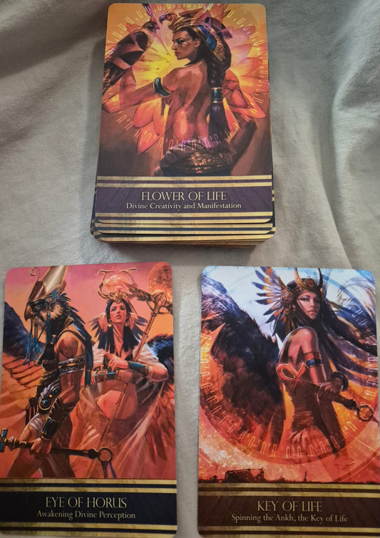 Three oracle cards: Flower of Life — Divine Creativity and Manifestation, Eye of Horus — Awakening Divine Perception, and Key of Life — Spinning the Ankh, the Key of Life.