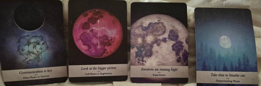 Four moon oracle cards: New Moon in Gemini, Full Moon in Sagittarius, Supermoon, and Disseminating Moon laid out for a daily collective reading