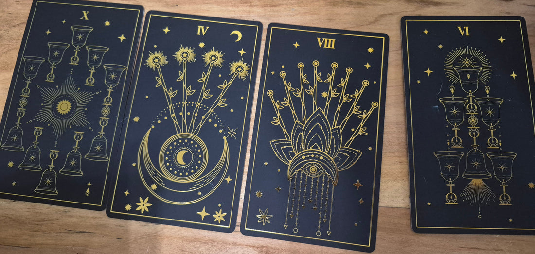 Four tarot cards laid on a wooden surface — Ten of Cups, Four of Wands, Eight of Wands, and Six of Cups — daily collective reading September 10 2026