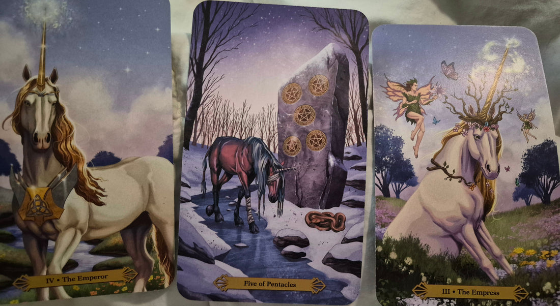 Three-card tarot spread featuring The Emperor, Five of Pentacles, and The Empress, illustrated with unicorns.