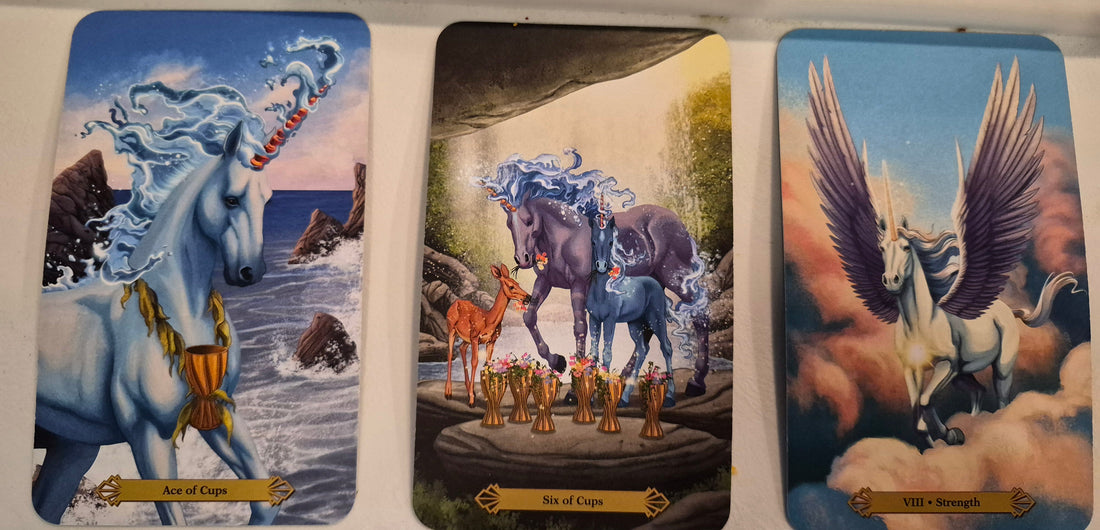 Daily collective tarot reading spread – Ace of Cups, Six of Cups, and Strength