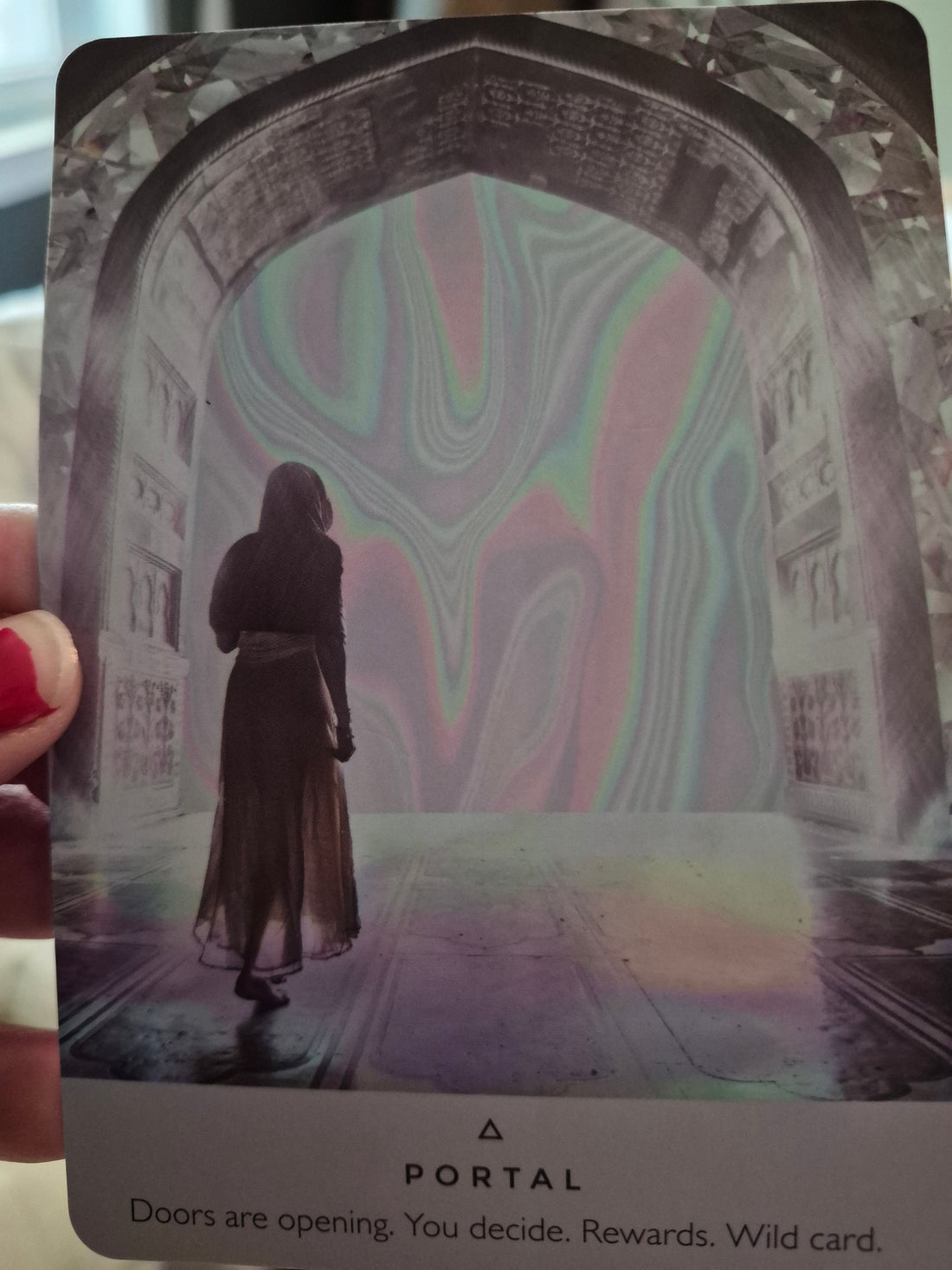 Portal oracle card – a figure standing at a shimmering iridescent doorway