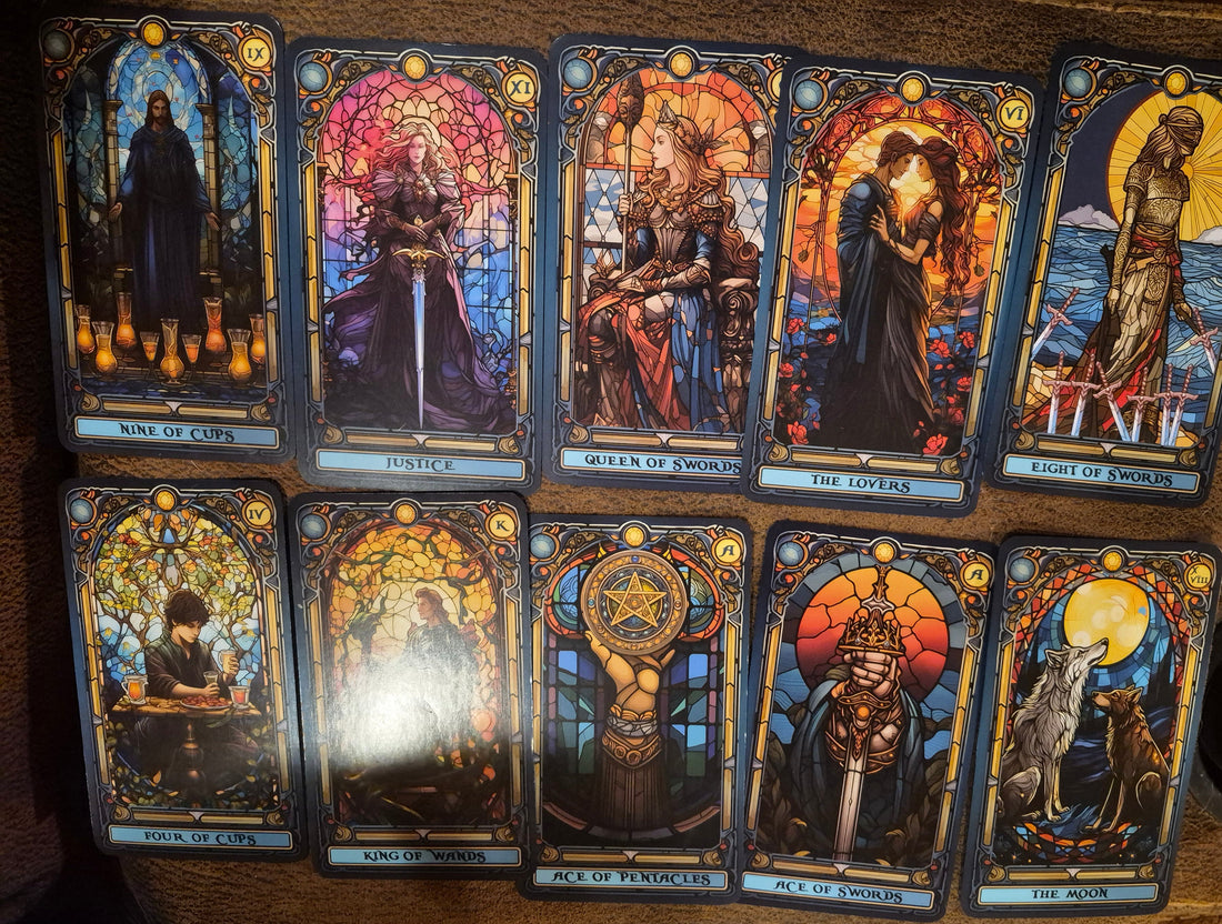 Daily collective tarot reading spread featuring 10 stained glass style tarot cards