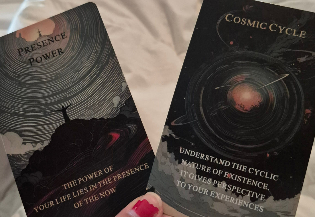 Two oracle cards: Presence Power and Cosmic Cycle held in hand for daily collective reading