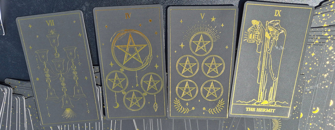 Four tarot cards laid out for the May 18 2026 daily collective reading: 7 of Cups, 4 of Pentacles, 5 of Pentacles, and The Hermit