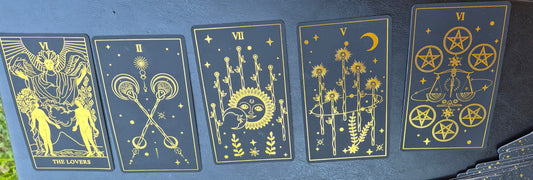 Five tarot cards laid out for the daily collective reading: The Lovers, Two of Wands, Seven of Wands, Five of Wands, and Six of Pentacles