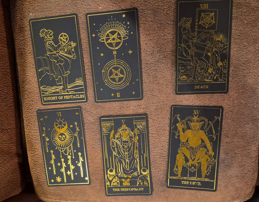 Six tarot cards laid out for the daily collective reading: Knight of Pentacles, II of Pentacles, Death, VI of Wands, The Hierophant, and The Devil