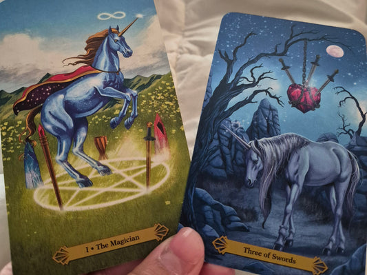 Daily collective tarot reading cards: The Magician and Three of Swords from a unicorn tarot deck
